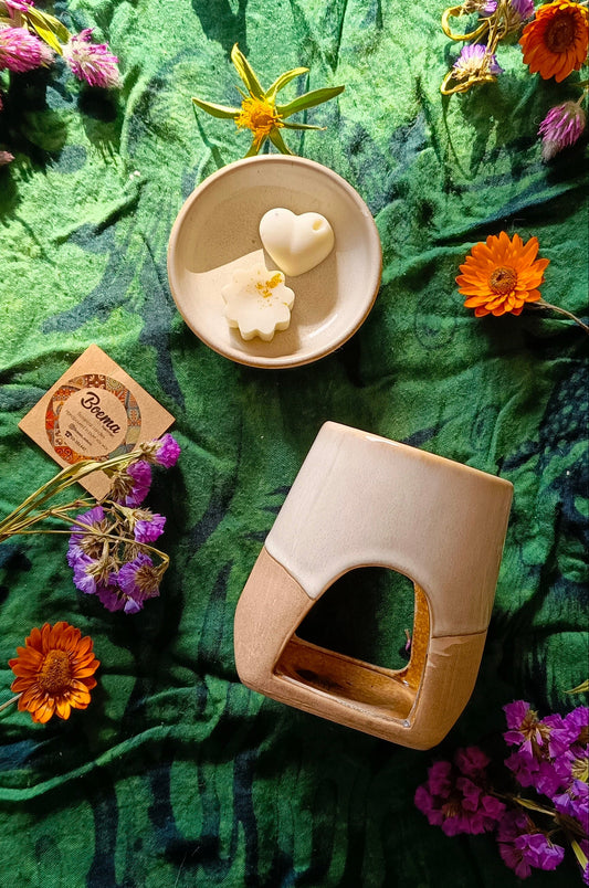 Ceramic burner and soy melts on a green fabric background with flowers