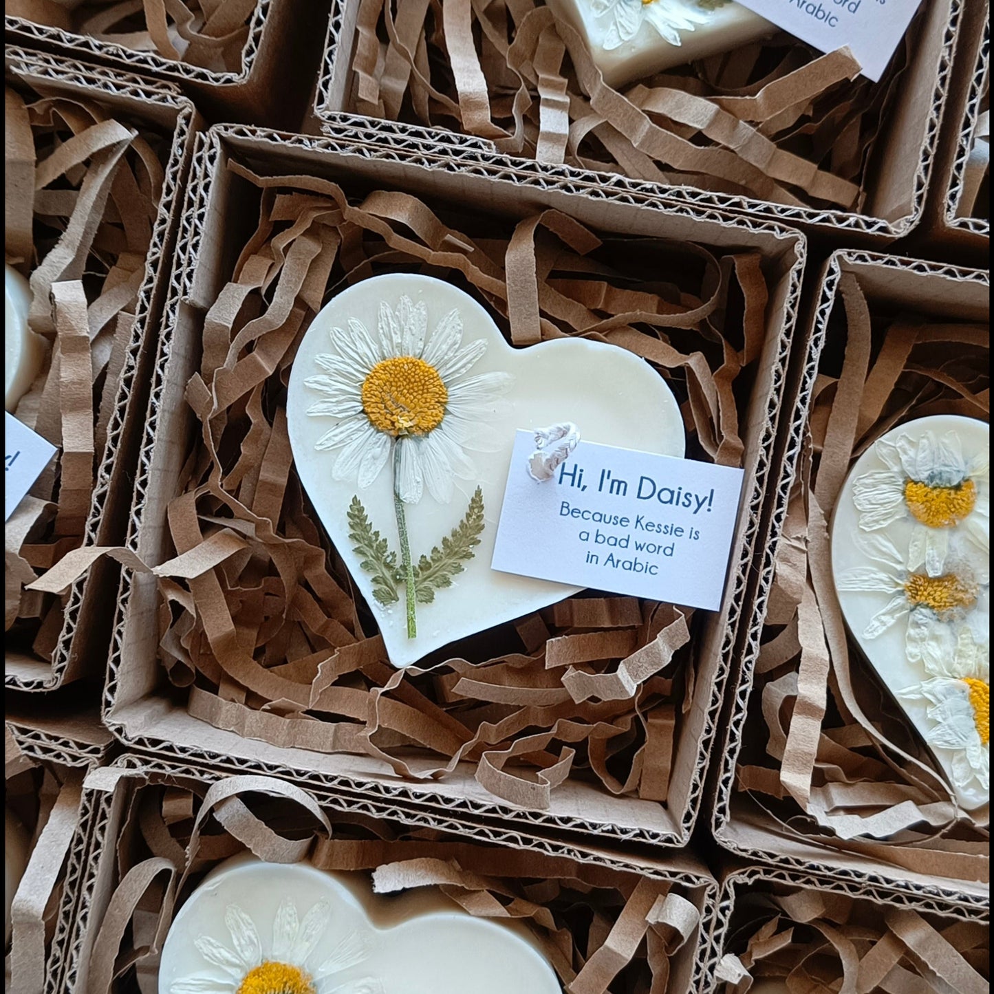 Heart-shaped small candles in boxes with floral designs